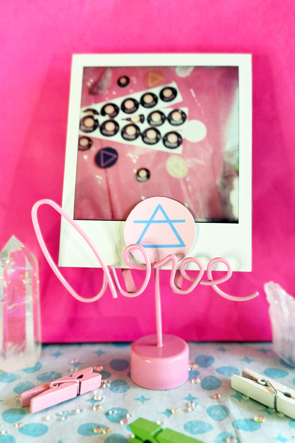 Pastel Pink Background with Baby Blue Image Matte Air Element Sign Sticker in a Setting in front of a Polaroid picture for Reference
