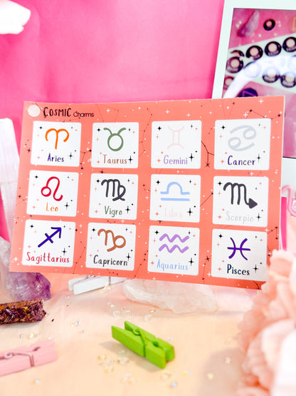 Crystals holding a Zodiac Symbols sticker sheet featuring colorful astrology icons for planners and journals